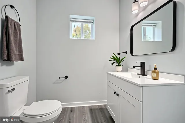 a bathroom with a toilet sink and mirror