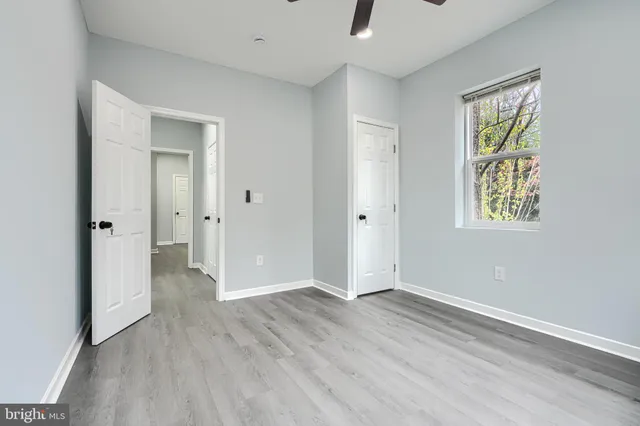 an empty room with windows and closet