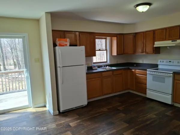 a kitchen with a refrigerator sink and cabinets