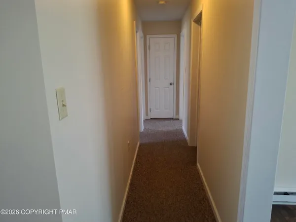 a view of a hallway with a door