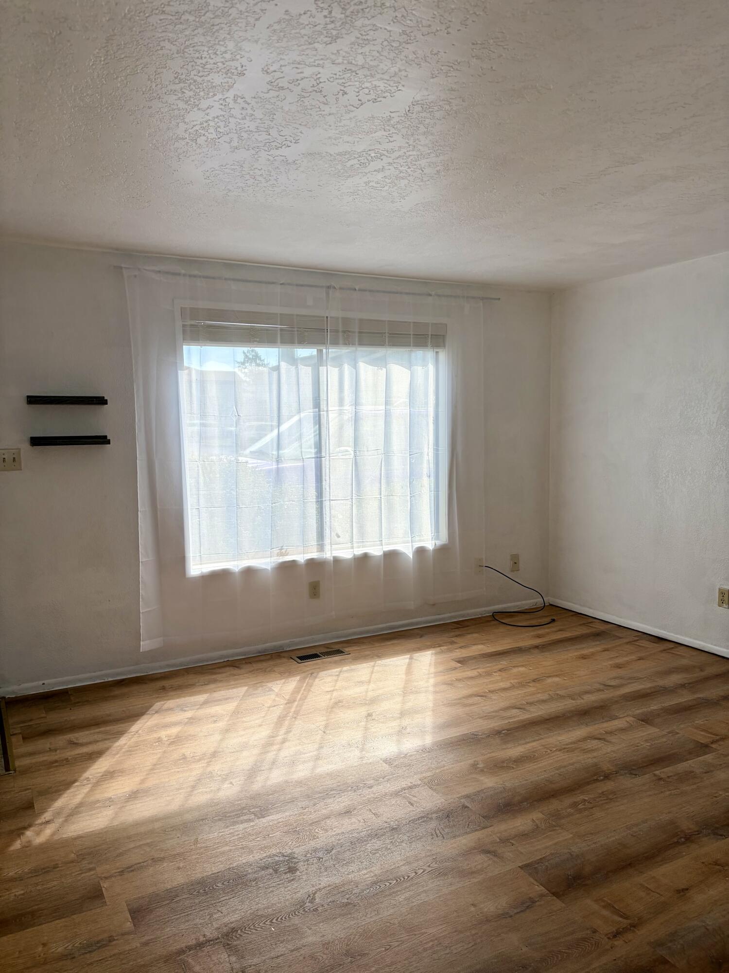 1198 Morrow Road, Unit A Medford, OR 97504 - Photo 5 of 20 a view of an empty room and window