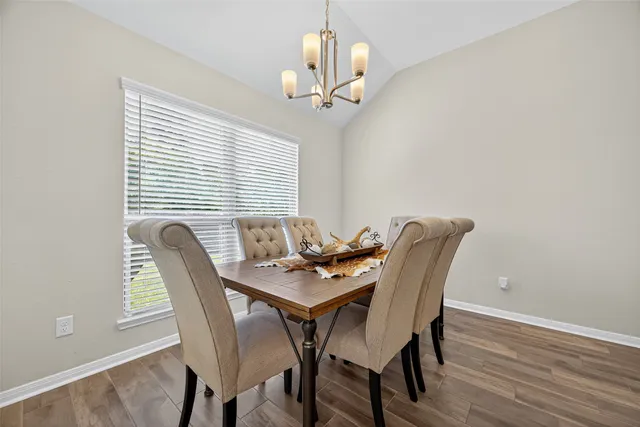 a view of a dining room with furniture and wooden floor