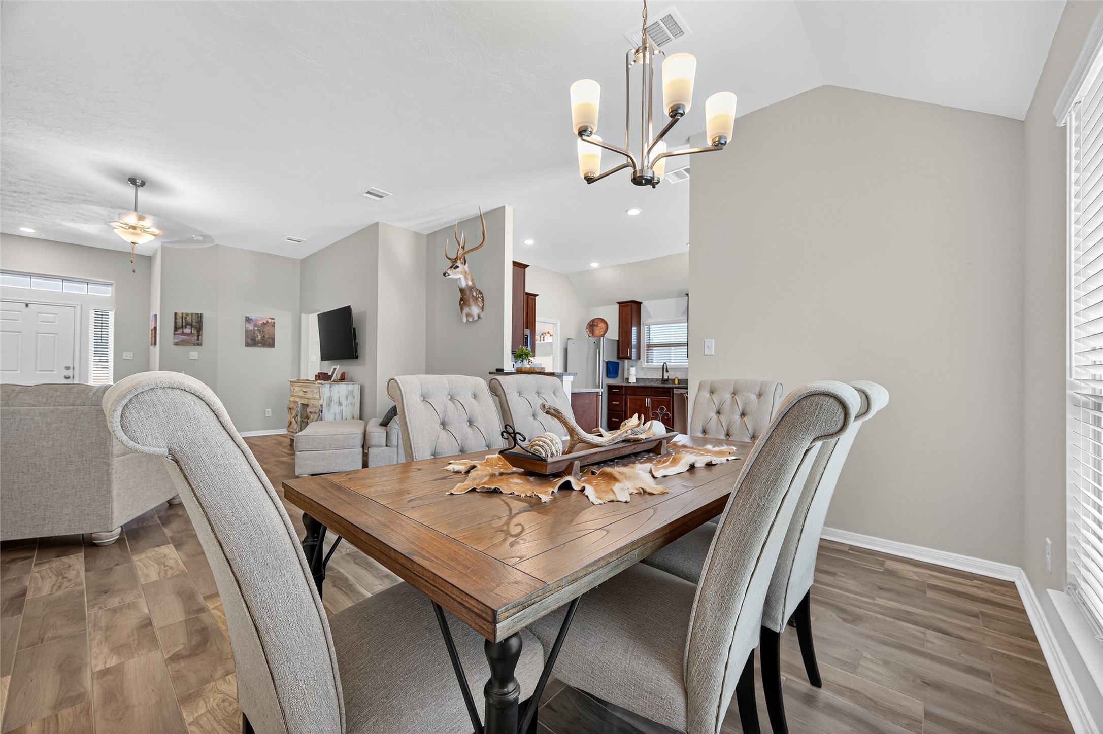 128 Red Deer Way Huntsville, TX 77320 - Photo 11 of 33 a view of a dining room with furniture and chandelier