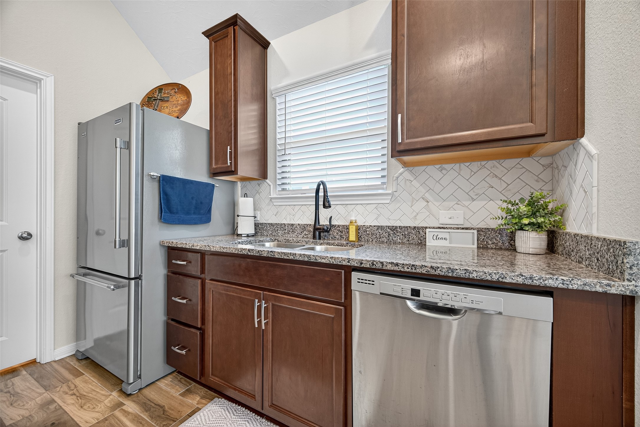 128 Red Deer Way Huntsville, TX 77320 - Photo 15 of 33 a kitchen with stainless steel appliances granite countertop a sink and a refrigerator