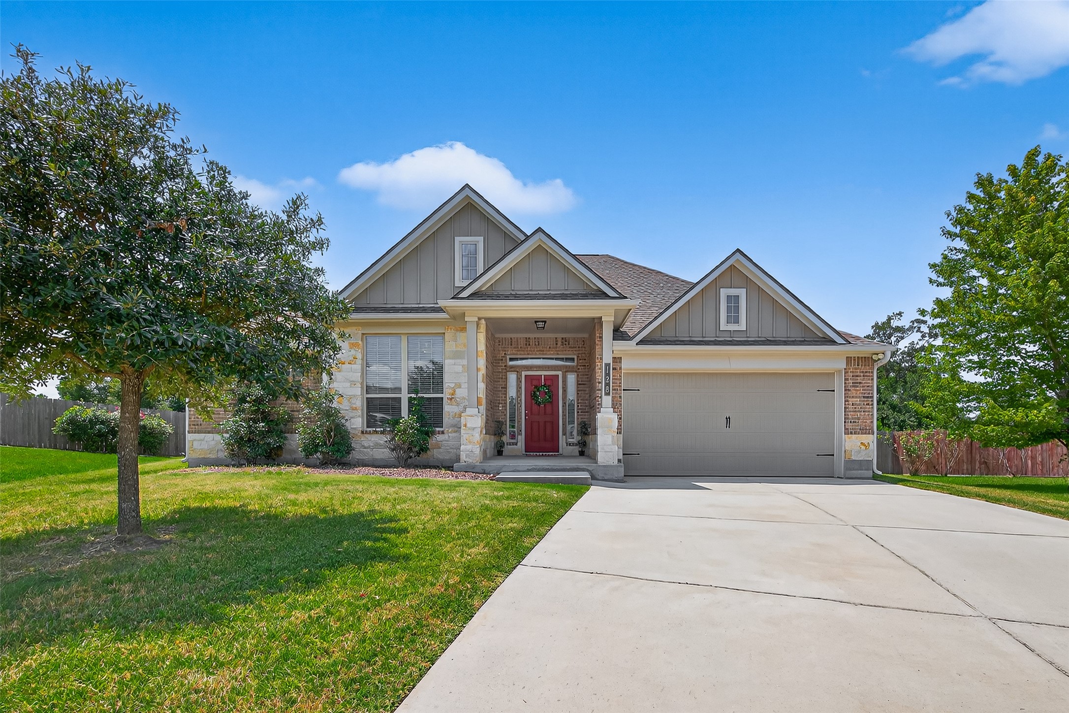 128 Red Deer Way Huntsville, TX 77320 - Photo 2 of 33 a front view of a house with yard and green space