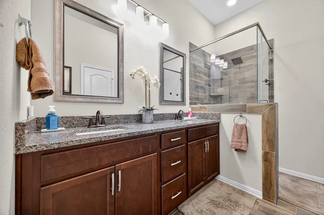 a bathroom with a granite countertop sink mirror and double