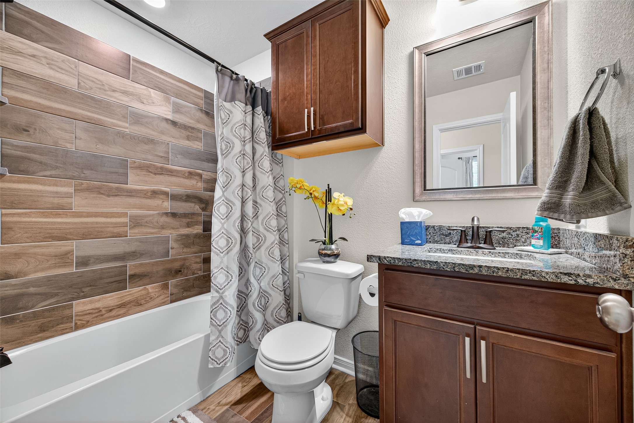 128 Red Deer Way Huntsville, TX 77320 - Photo 25 of 33 a bathroom with a granite countertop sink toilet and shower