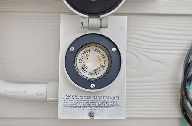 a view of a backyard with potted plants and wooden fence