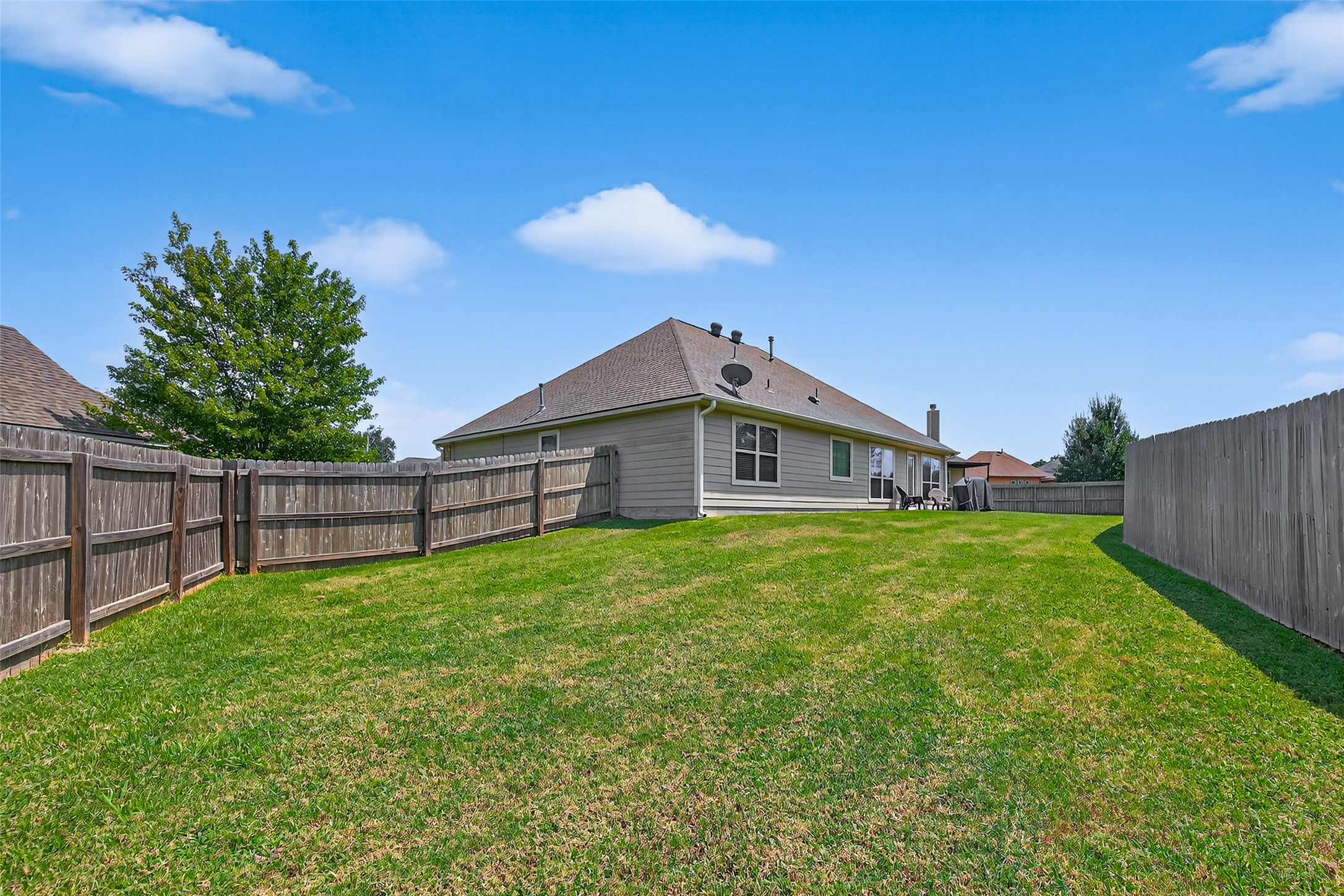 128 Red Deer Way Huntsville, TX 77320 - Photo 30 of 33 a view of a backyard with potted plants and wooden fence