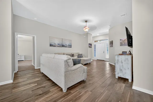 a living room with furniture and wooden floor