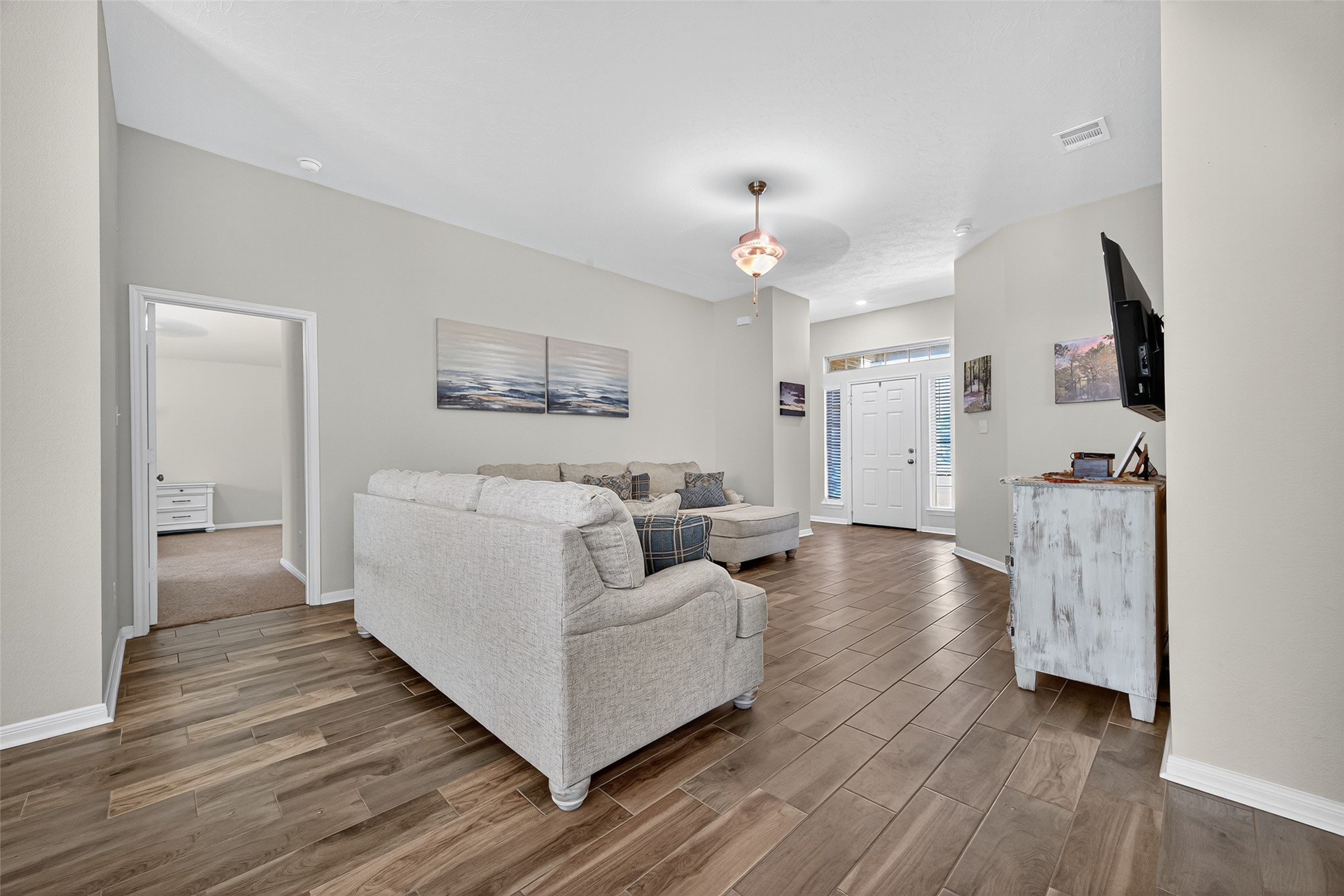 128 Red Deer Way Huntsville, TX 77320 - Photo 7 of 33 a living room with furniture and a wooden floor