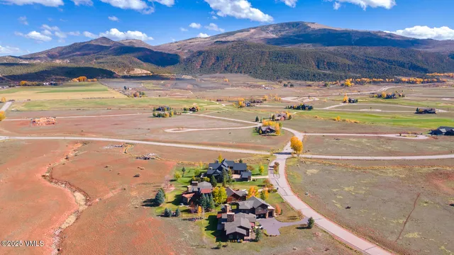 a dining room with furniture a chandelier and wooden floor