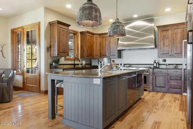 a living room with furniture a fireplace and a large window