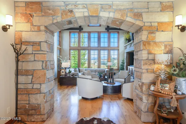 a living room with furniture a fireplace and a chandelier