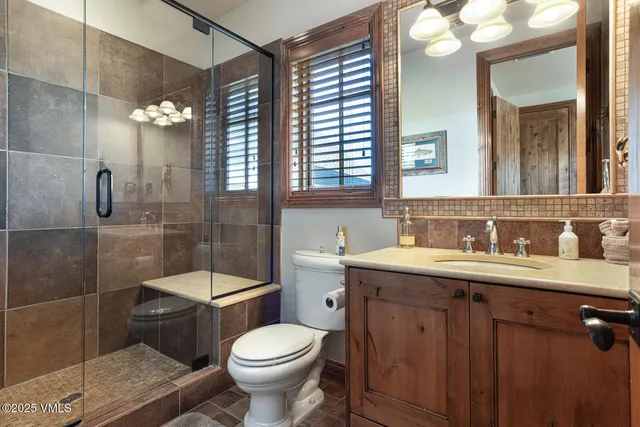 a large kitchen with kitchen island a sink a stove a refrigerator and cabinets