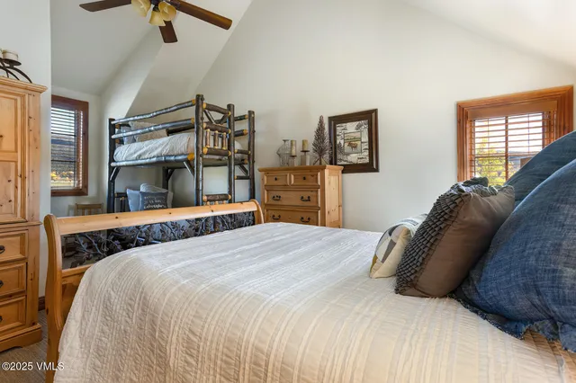 a living room with furniture a flat screen tv and a dining table with wooden floor
