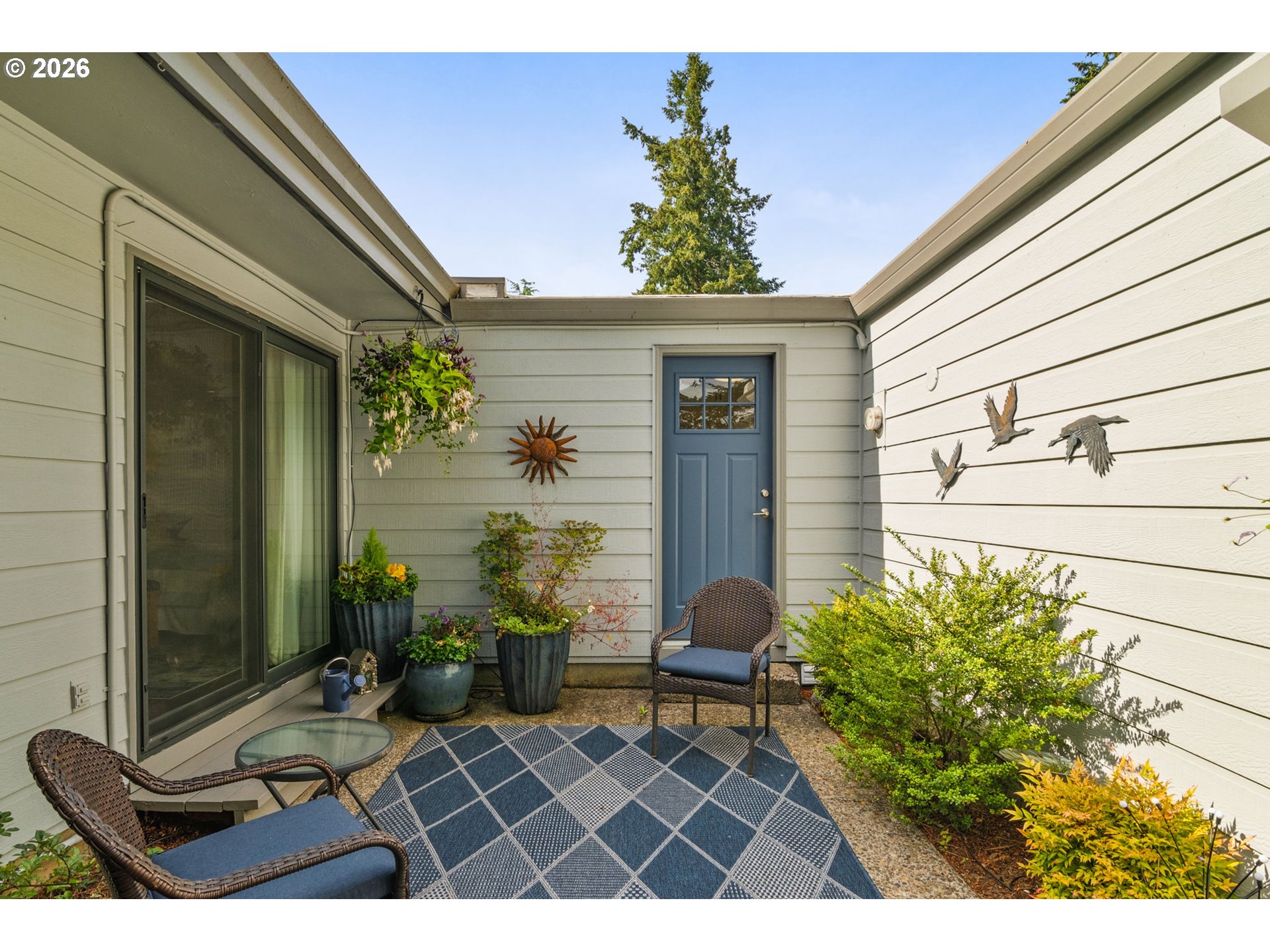 1200 Northeast Territorial Road, Unit 12 Canby, OR 97013 - Photo 31 of 38 a view of a porch with chairs and potted plants