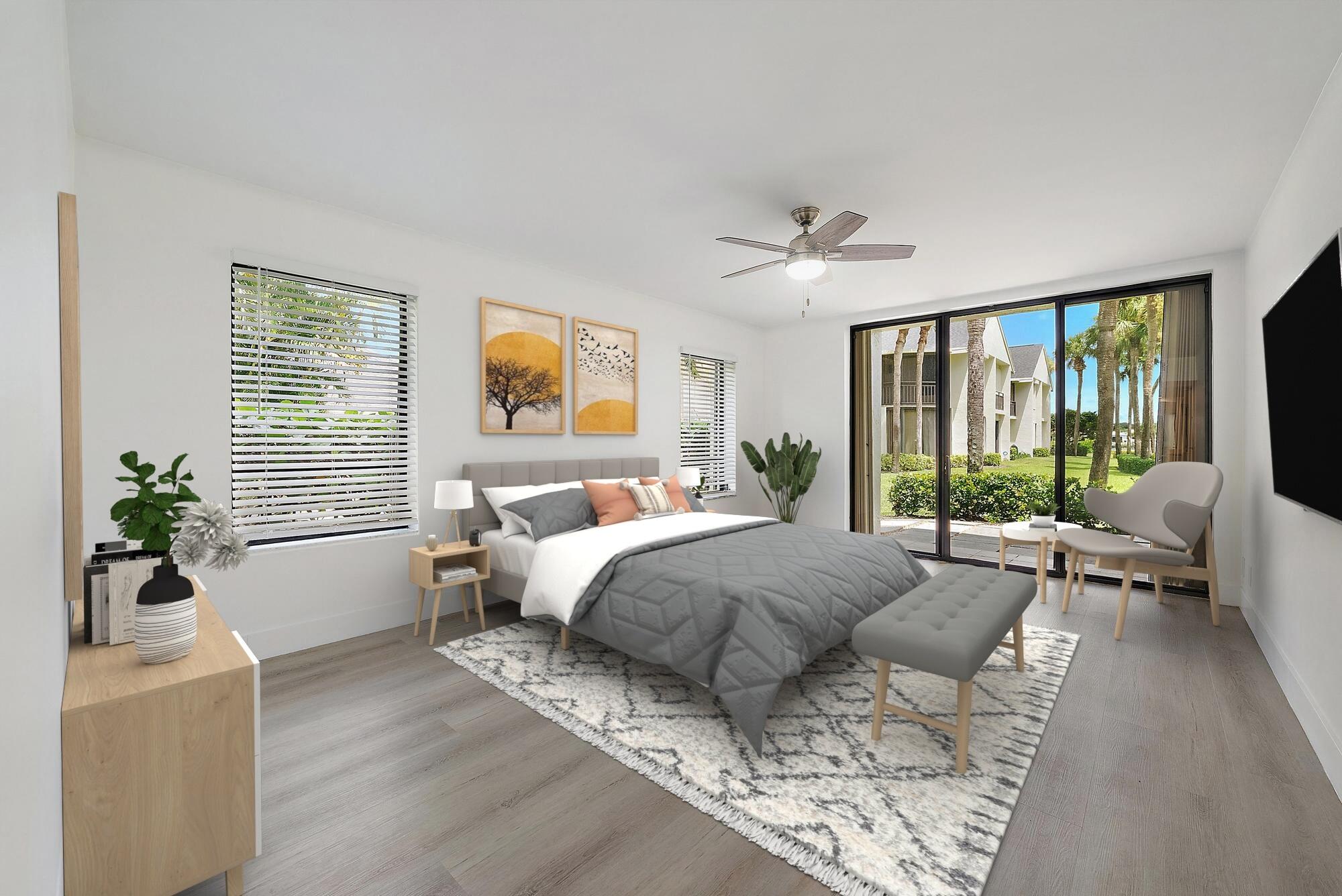 10459 Southeast Terrapin Place, Unit 101D Jupiter, FL 33469 - Photo 16 of 49 a spacious bedroom with a large bed and a large window