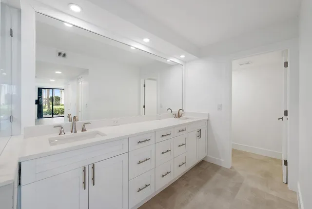 a bathroom with double sink and a mirror