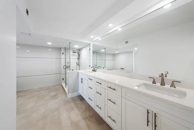 a bathroom with double sink and a mirror