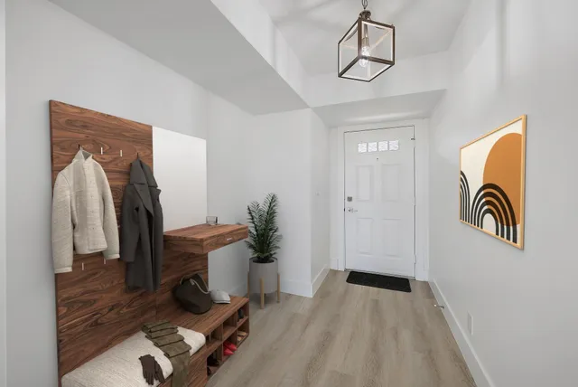 a view of entryway with workspace and mirror