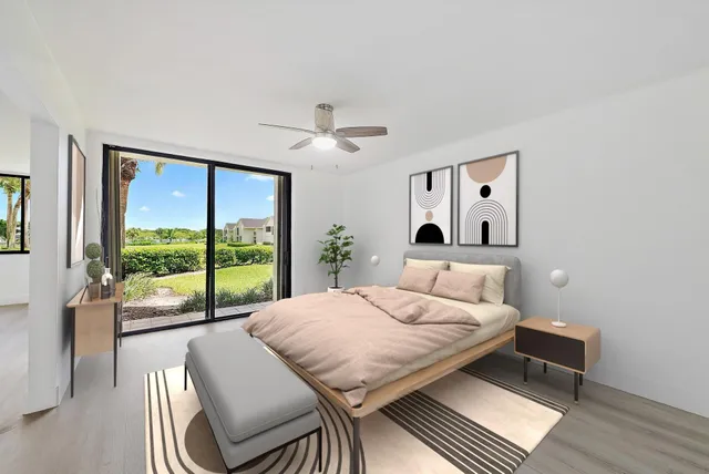 a bedroom with a bed and a large window