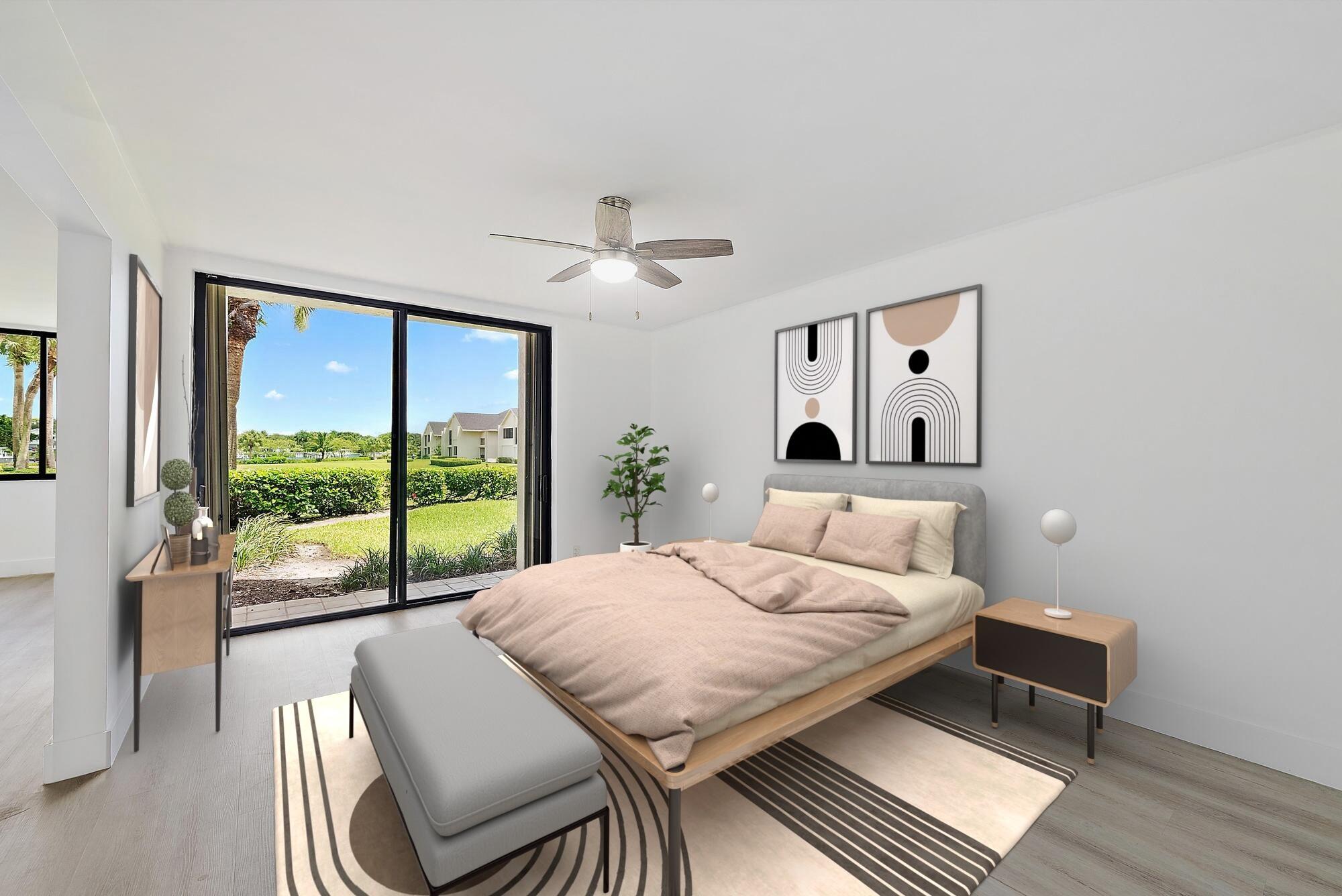 10459 Southeast Terrapin Place, Unit 101D Jupiter, FL 33469 - Photo 22 of 49 a bedroom with a bed and a large window