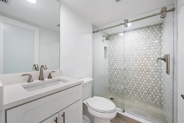 a bathroom with a sink toilet and shower