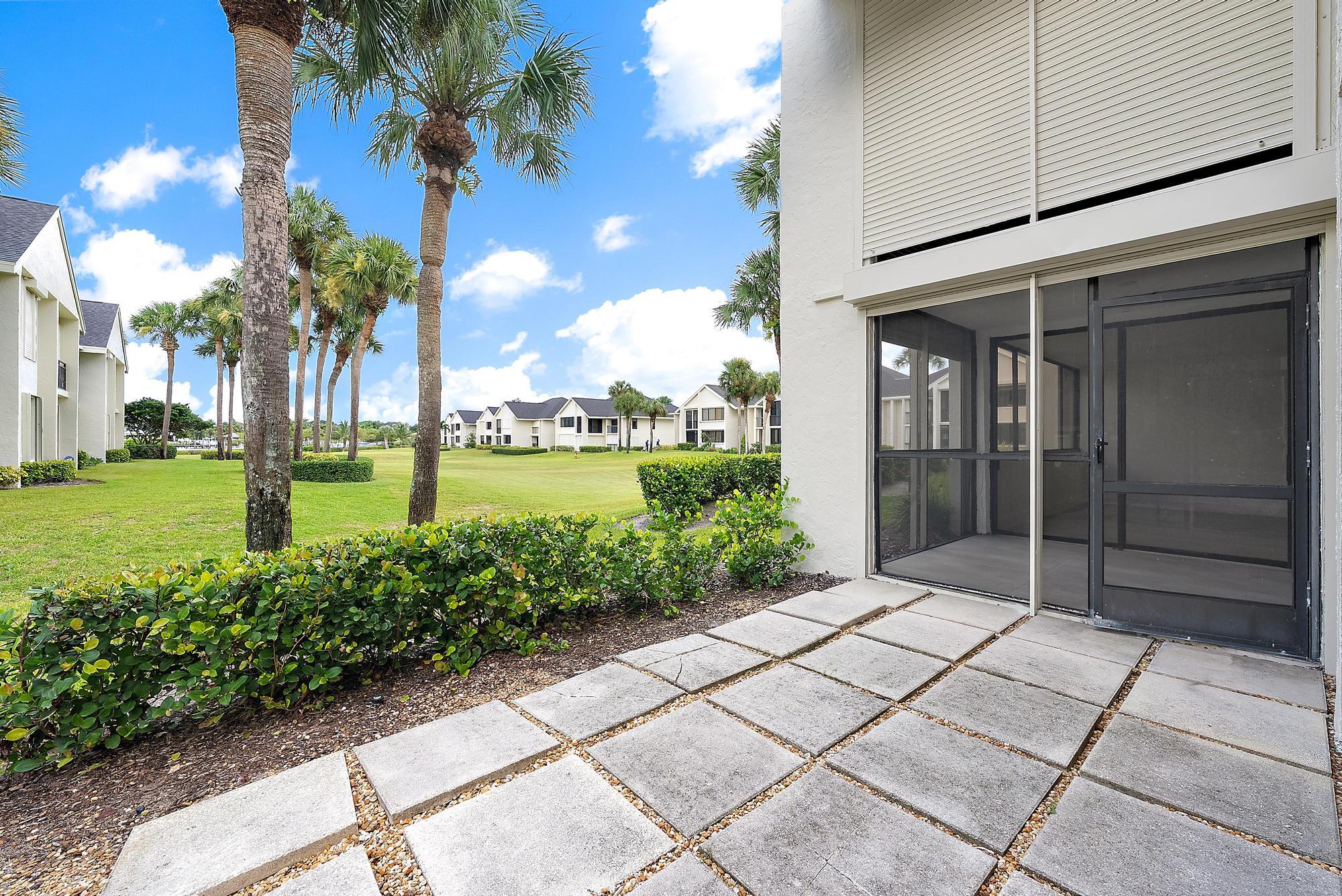 10459 Southeast Terrapin Place, Unit 101D Jupiter, FL 33469 - Photo 30 of 49 a view of a garden with an empty space