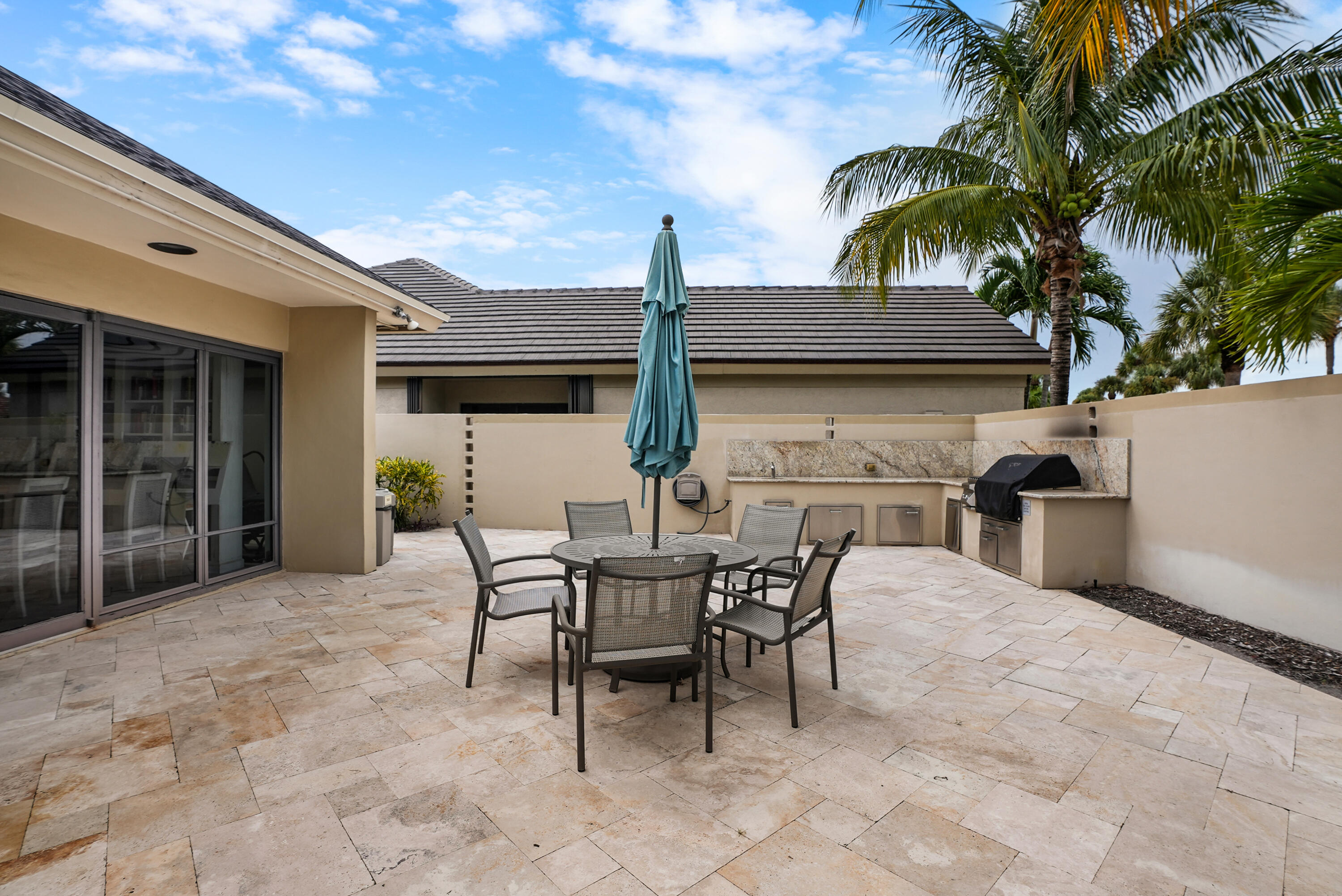 10459 Southeast Terrapin Place, Unit 101D Jupiter, FL 33469 - Photo 44 of 49 a view of a patio with table and chairs and potted plants