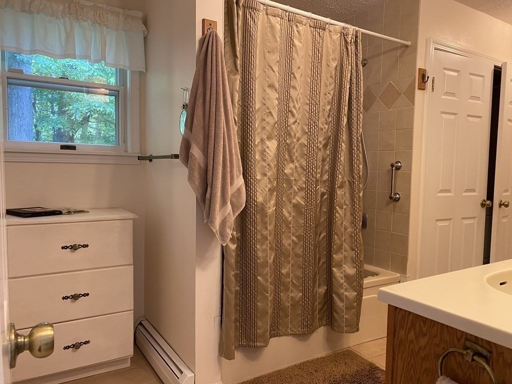 76 Main Road Gill, MA 01354 - Photo 17 of 36 a bathroom with a shower curtain and a sink