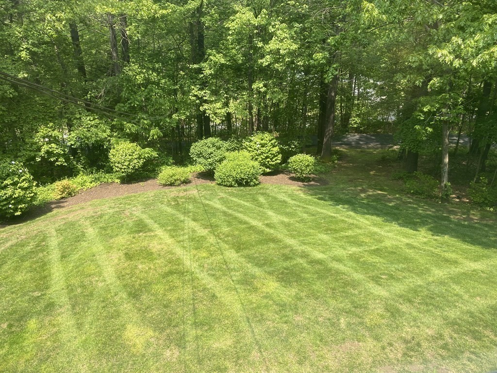76 Main Road Gill, MA 01354 - Photo 28 of 36 a backyard of a house with a yard and seating area