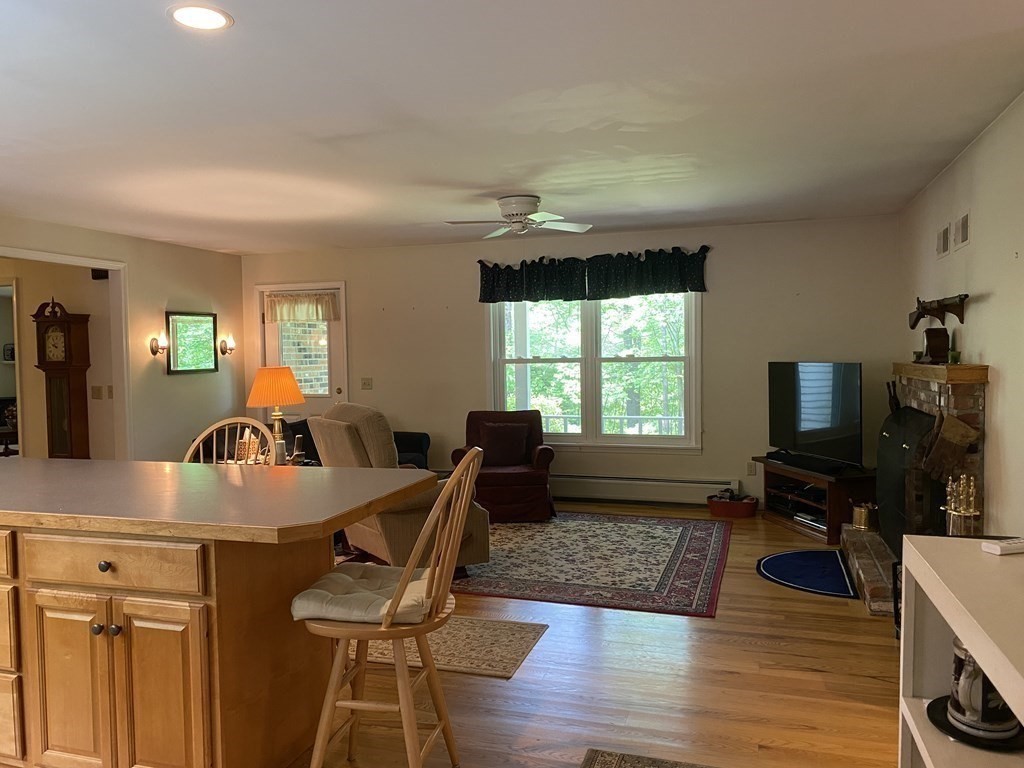 76 Main Road Gill, MA 01354 - Photo 8 of 36 a living room with furniture a large window and wooden floor