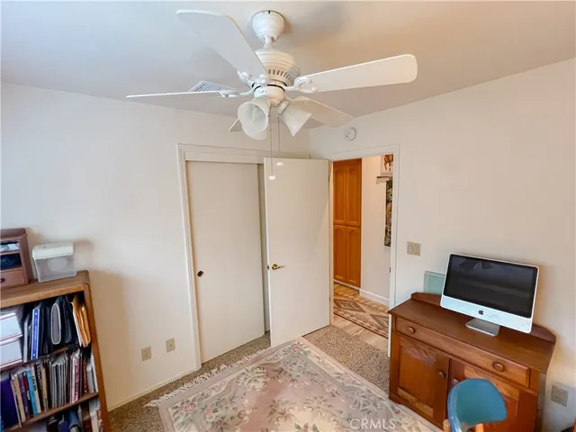 a living room with furniture a flat screen tv and a dresser