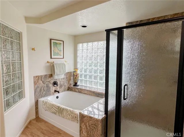 a view of a white house with a swimming pool and sitting area