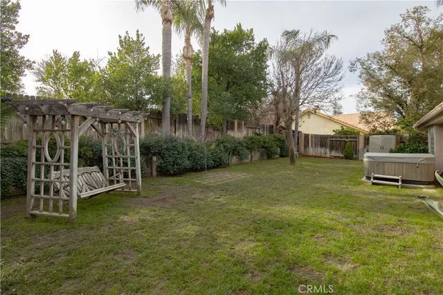 an aerial view of a house with pool and red chairs