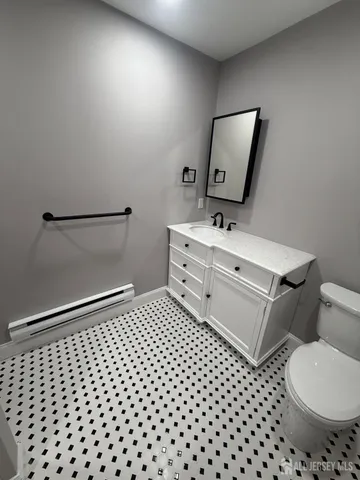 a bathroom with a sink toilet and mirror