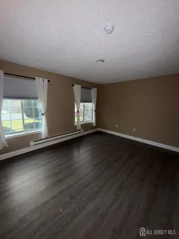 a view of a livingroom with wooden floor and window