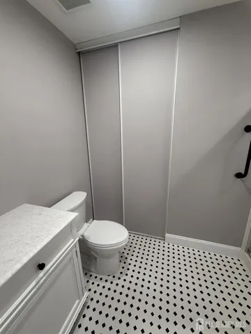 a bathroom with a sink a toilet a mirror and vanity