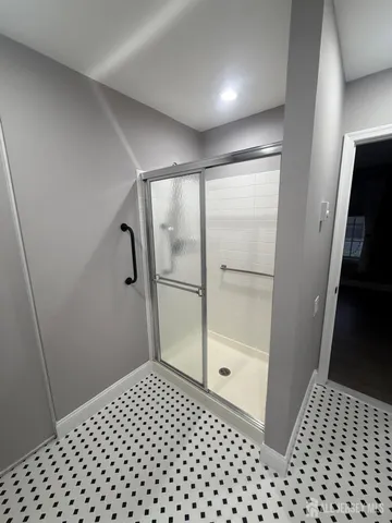 a bathroom with a glass door shower