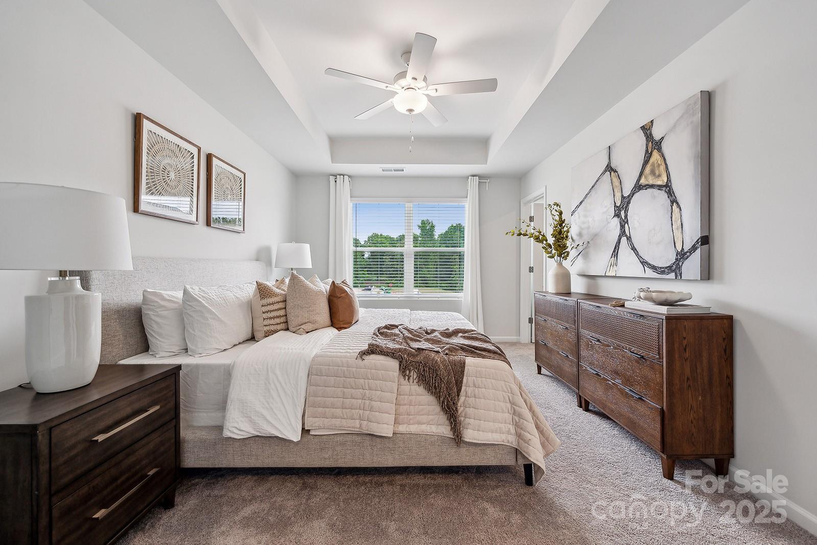 4742 Lakeview Road, Unit 17 Charlotte, NC 28216 - Photo 11 of 27 a spacious bedroom with a bed a dresser with wooden floor