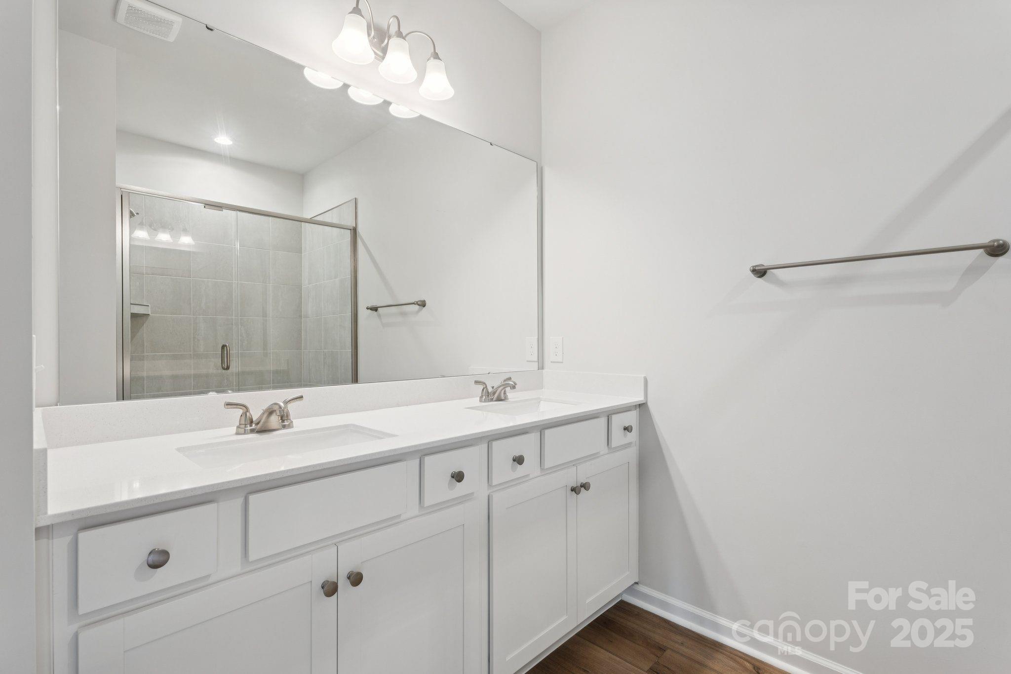 4742 Lakeview Road, Unit 17 Charlotte, NC 28216 - Photo 19 of 27 a bathroom with a double vanity sink and a mirror