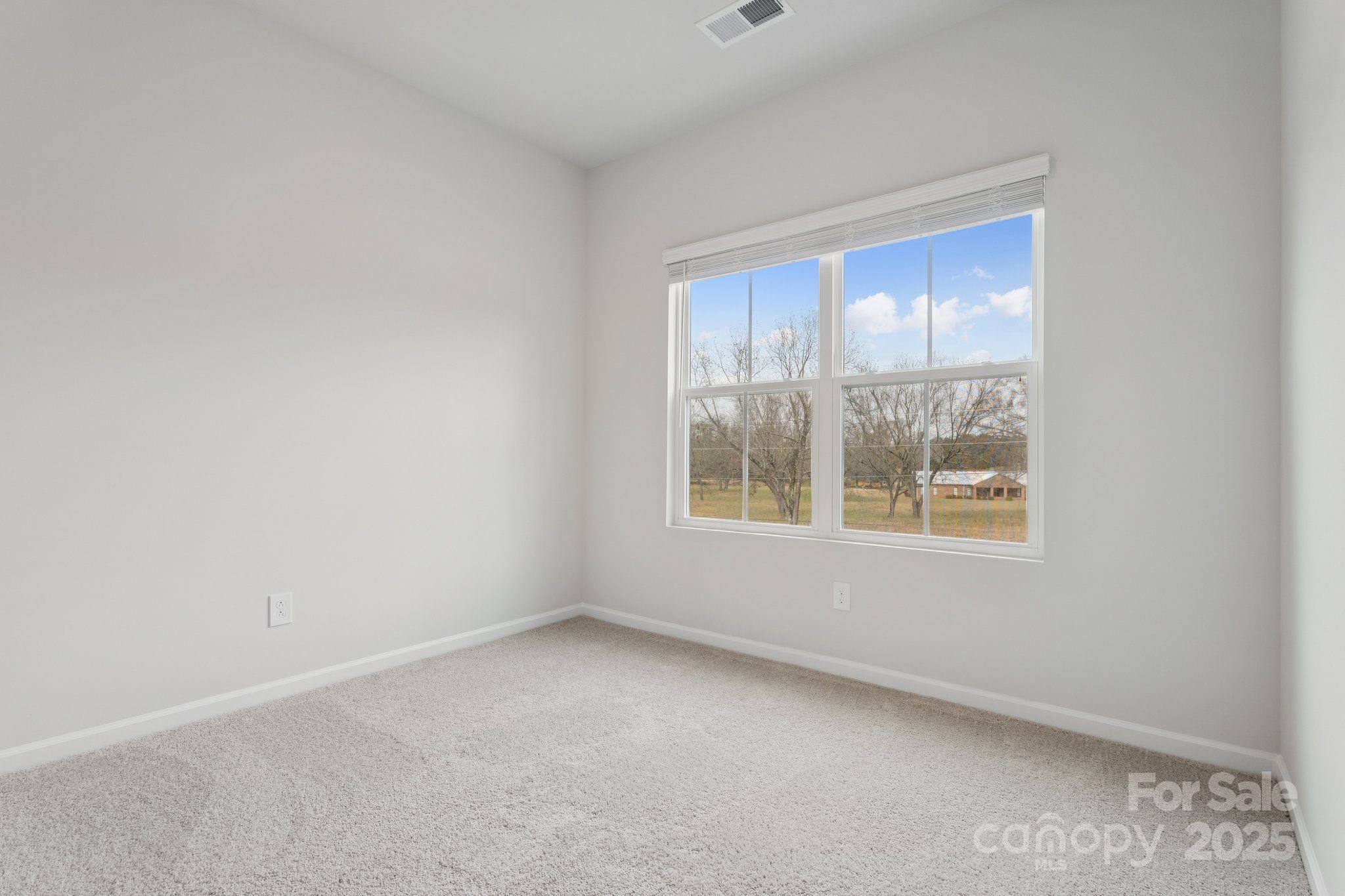 4742 Lakeview Road, Unit 17 Charlotte, NC 28216 - Photo 22 of 27 an empty room with a window