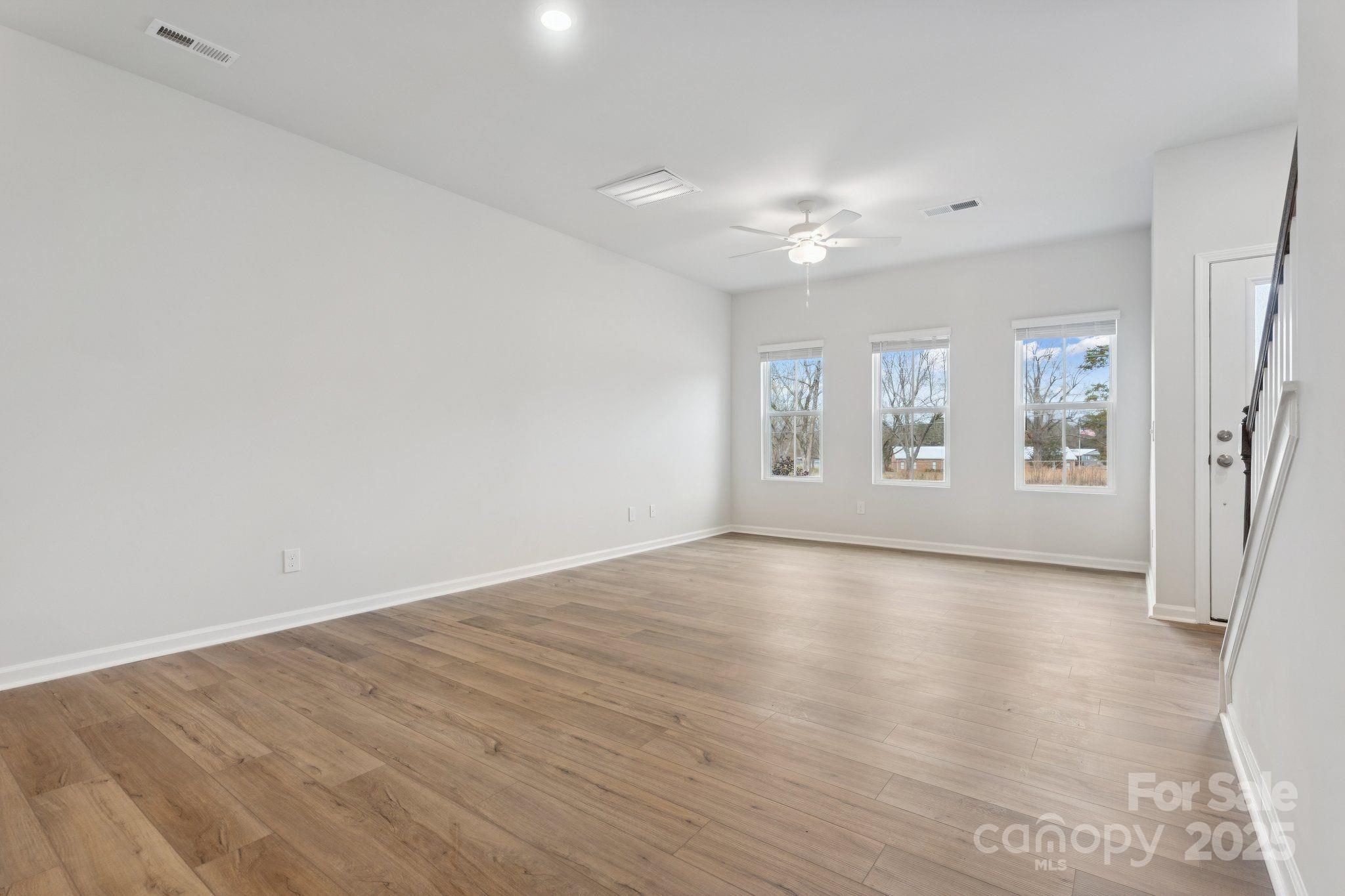 4742 Lakeview Road, Unit 17 Charlotte, NC 28216 - Photo 4 of 27 an empty room with wooden floor and windows
