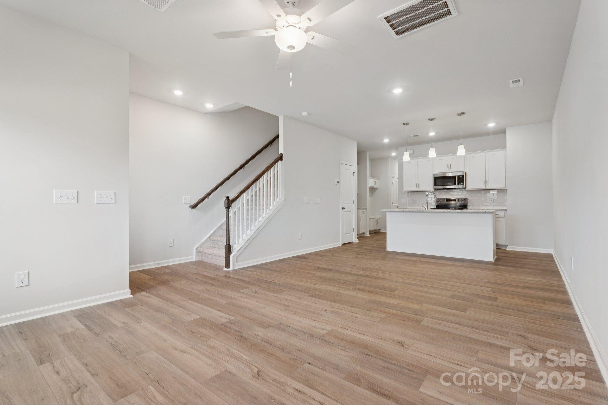 4742 Lakeview Road, Unit 17 Charlotte, NC 28216 - Photo 7 of 27 a view of a kitchen with a sink and a ceiling fan