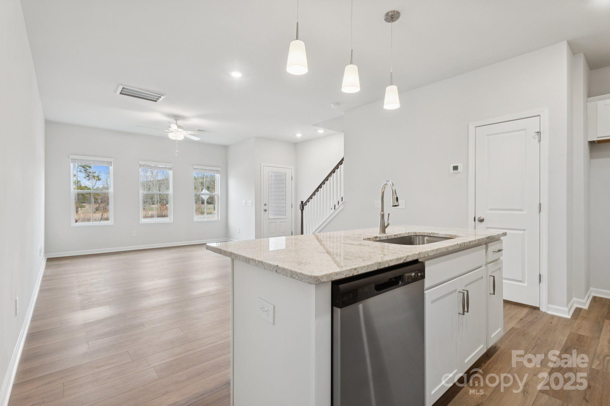 4742 Lakeview Road, Unit 17 Charlotte, NC 28216 - Photo 9 of 27 a kitchen with sink cabinets and wooden floor
