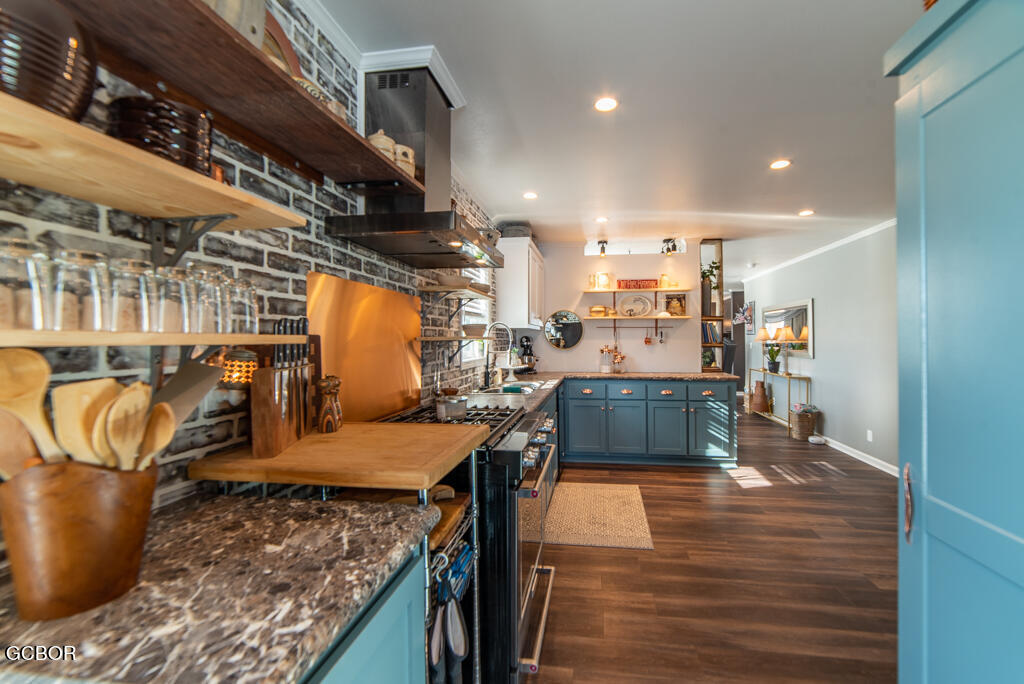 551 Summit Trail, Unit 199 Granby, CO 80446 - Photo 12 of 34 a kitchen with stainless steel appliances granite countertop a table chairs and a wooden floors