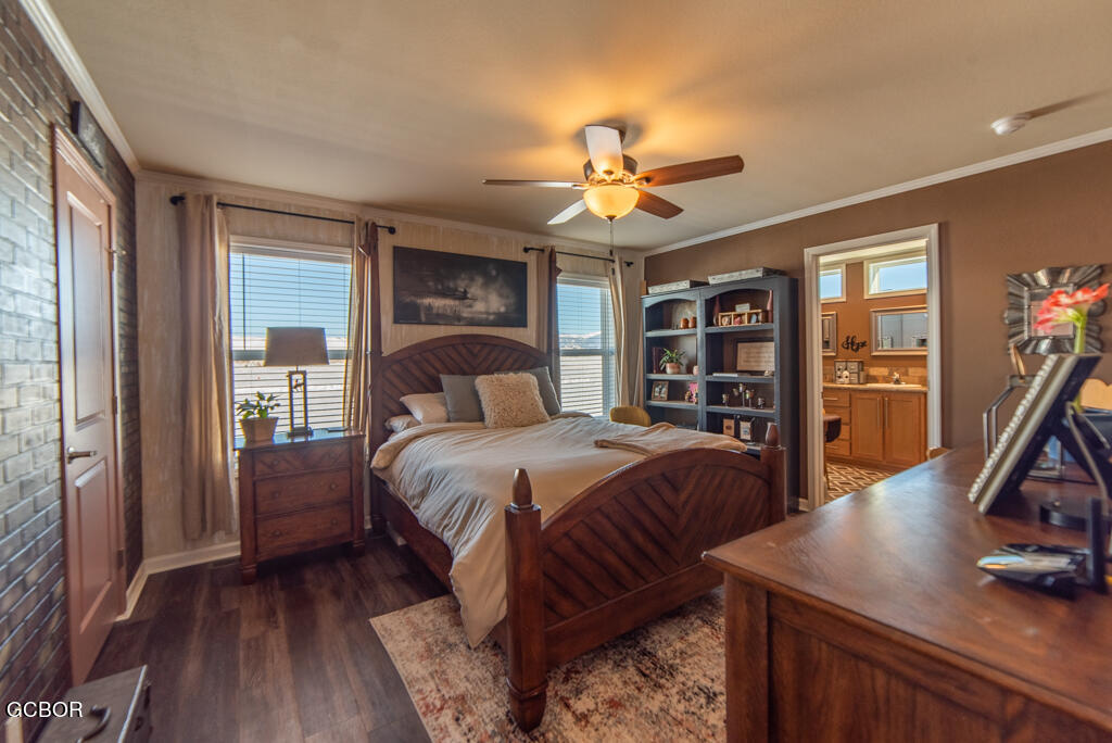 551 Summit Trail, Unit 199 Granby, CO 80446 - Photo 14 of 34 a bedroom with a large bed a flat tv screen and dresser