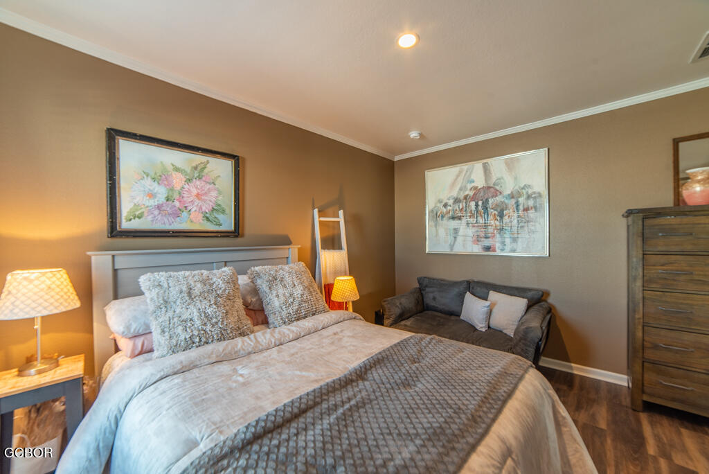 551 Summit Trail, Unit 199 Granby, CO 80446 - Photo 20 of 34 a bedroom with bed and wooden floor