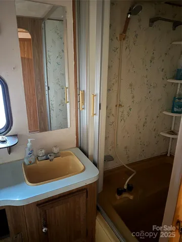 a bathroom with a toilet and a mirror